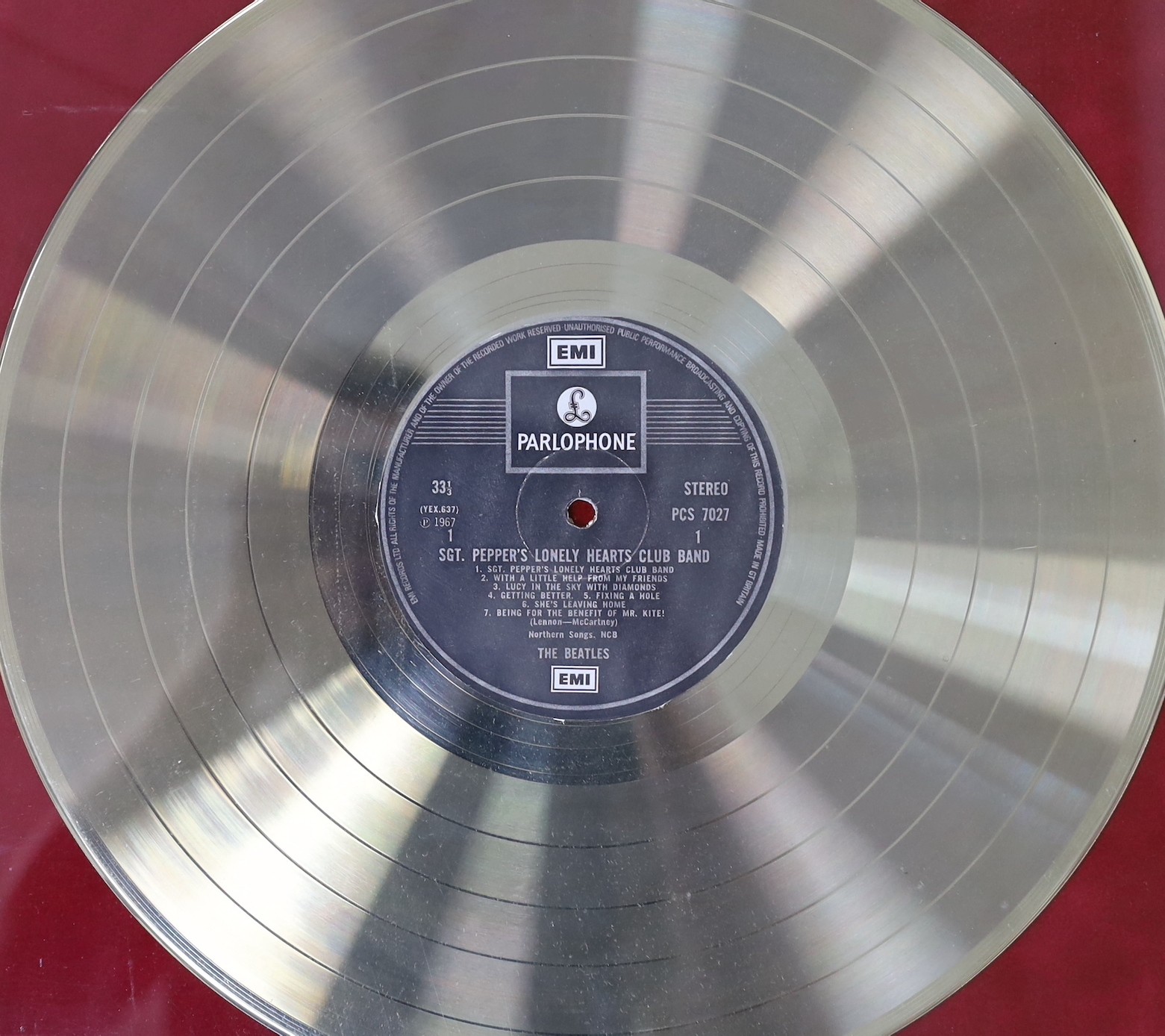 Sgt. Peppers Lonely Hearts Club Band, a framed gold disc, presented to EMI to recognise sales in the United Kingdom, of more than 100,000 copies, frame 41 x 50cm